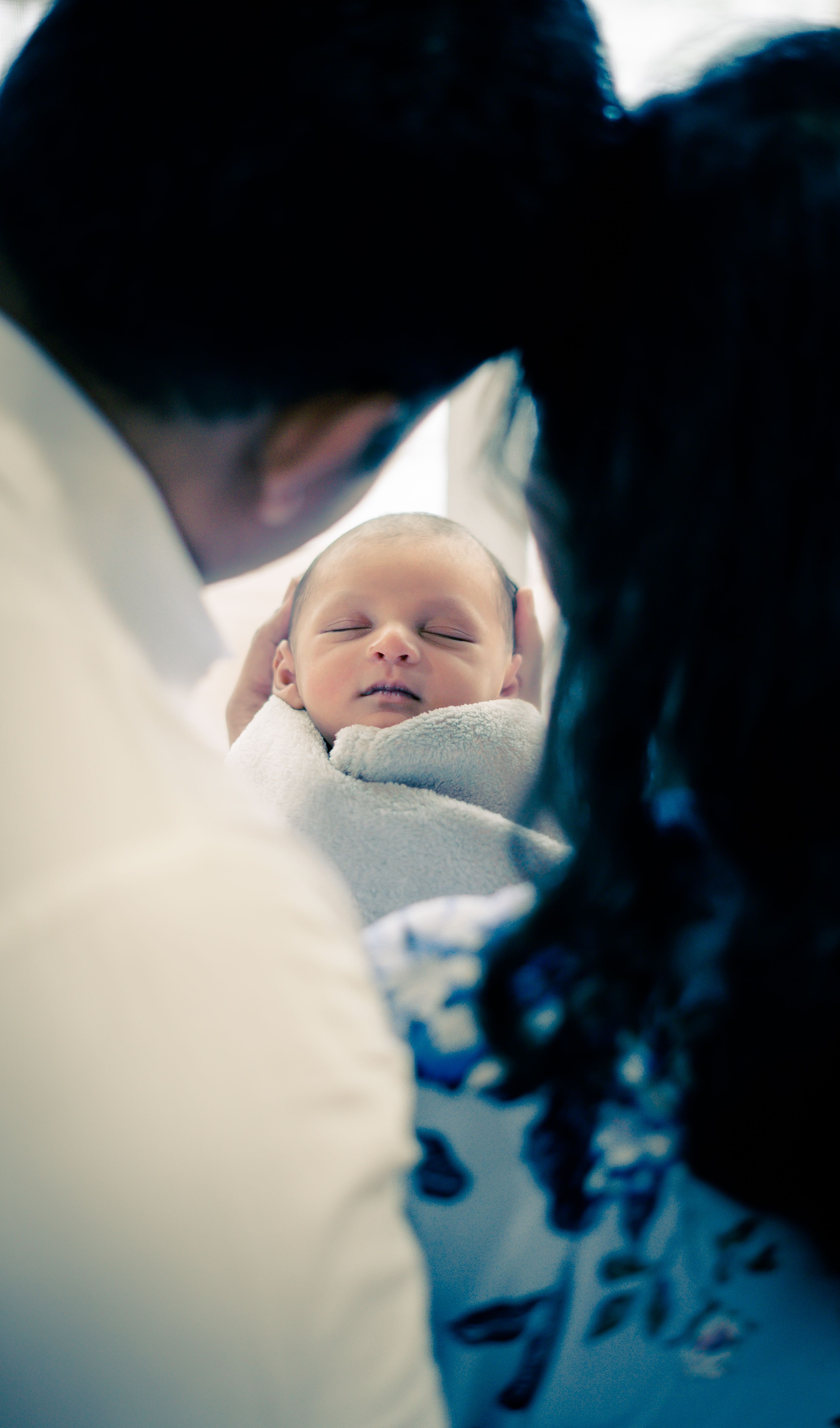 Parents gazing at their newborn
