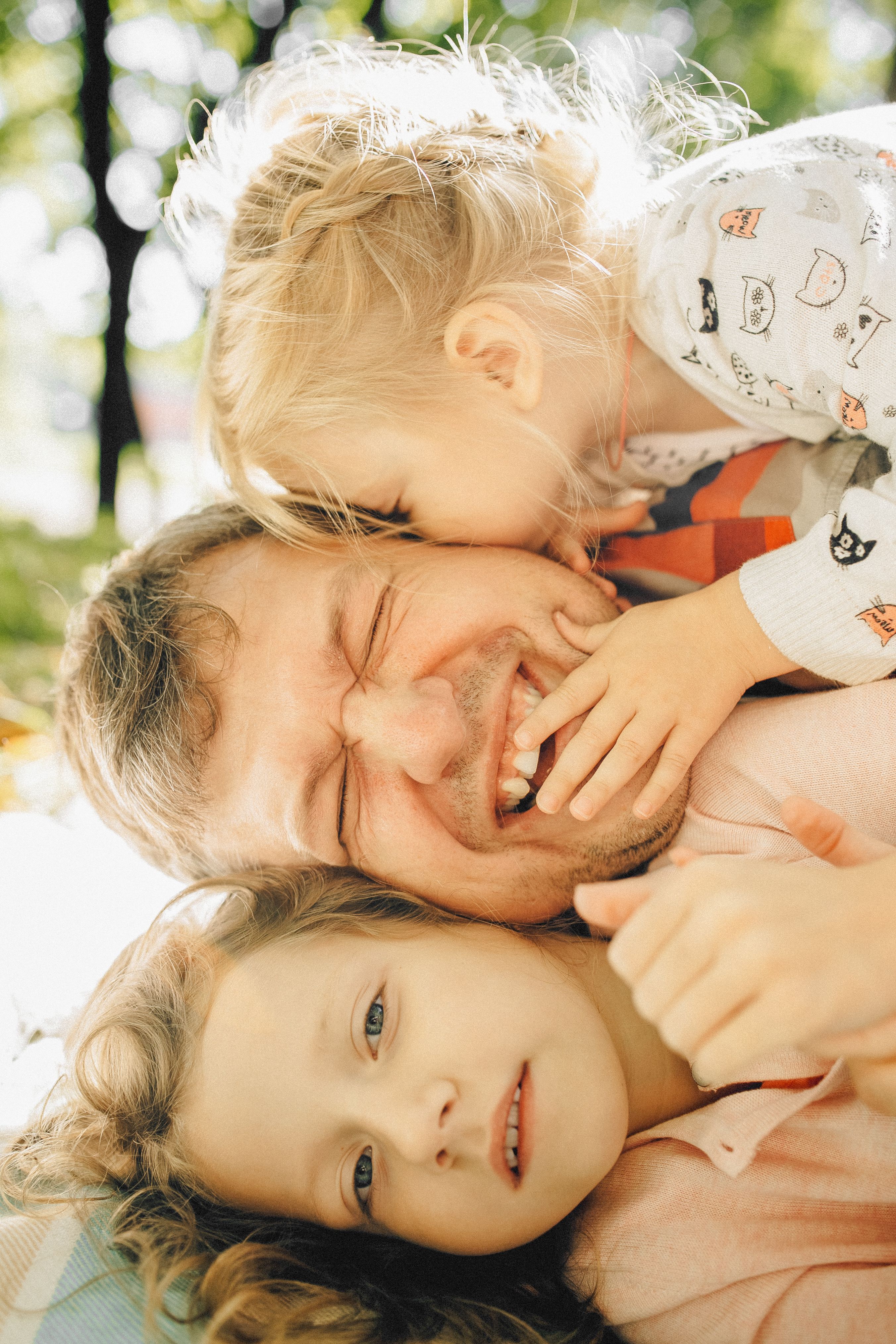A father in glasses holding his newborn daughter